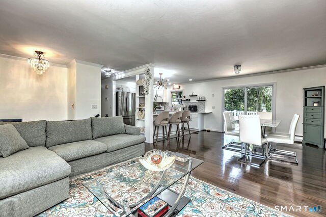 Open living and dining area at 22 Caldwell Drive with hardwood floors