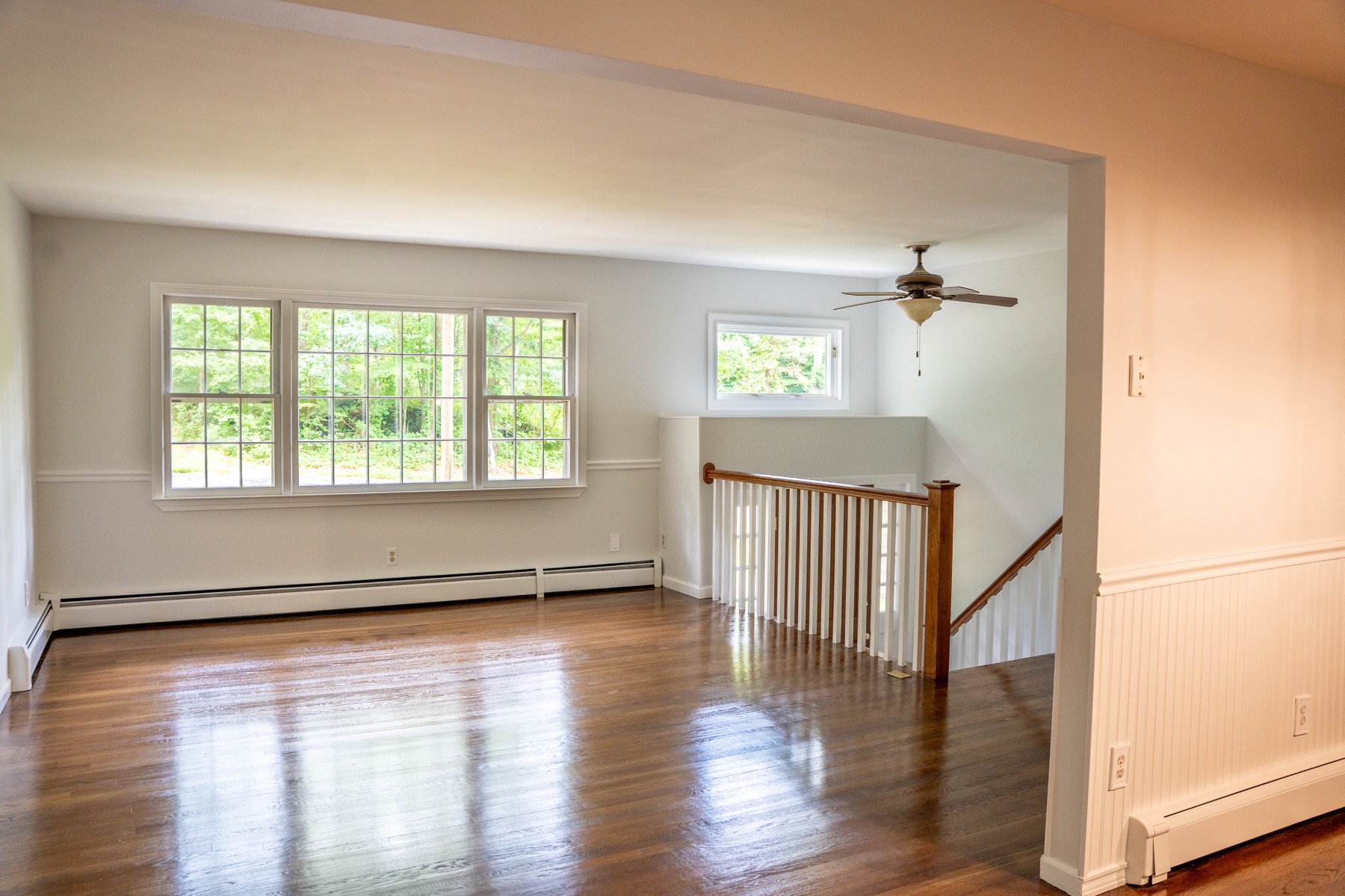 Sun filled living room with hardwood floors